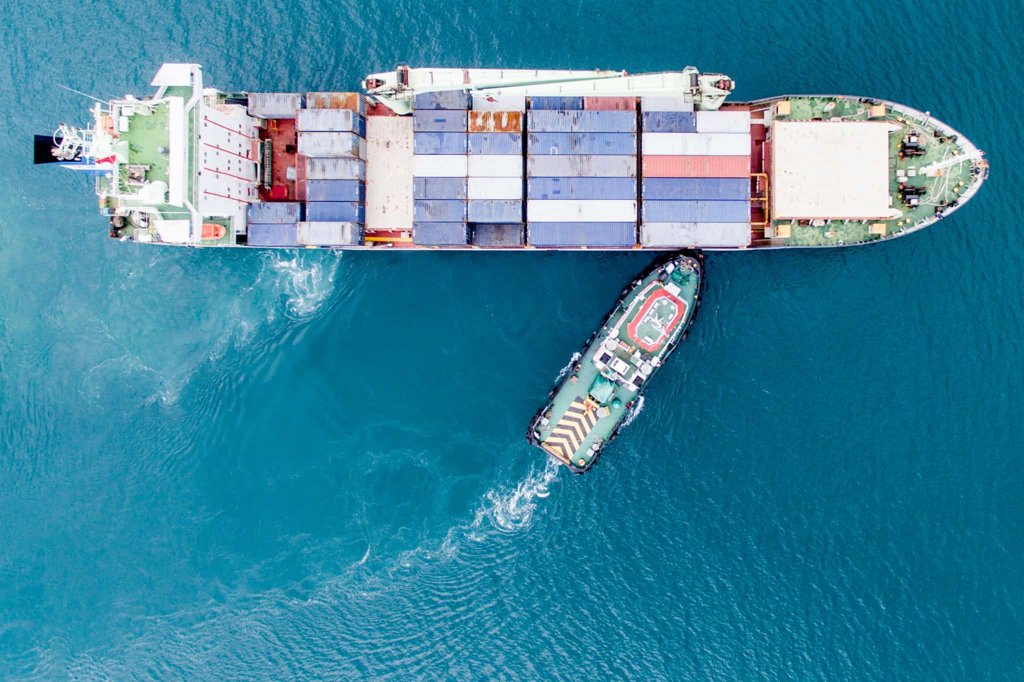 Aerial Photography of Container Ship and Tug Boat